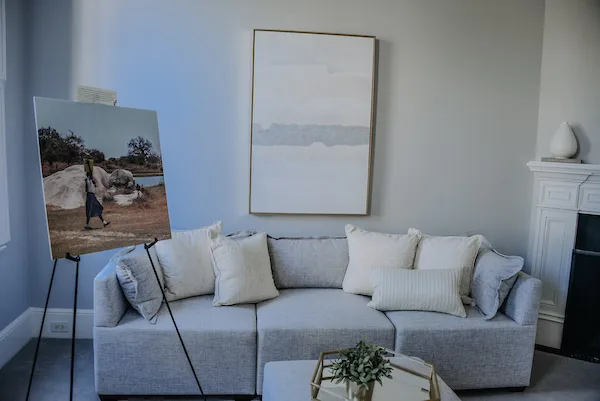 Large canvas print displayed on an easel in a client's living room, printed by RB Printing