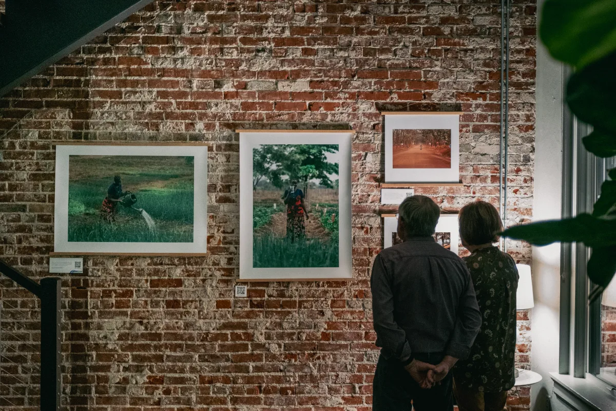 Visitors viewing large-format photo prints from a Water Mission exhibit, printed by RB Printing