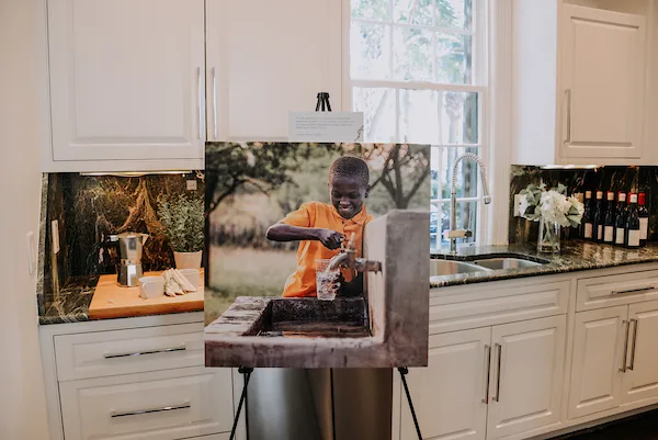 Gallery canvas print of a Water Mission photo, displayed on an easel in a client's home, printed by RB Printing